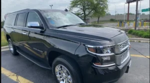 Our Luxury Black Suburban Car Stands in a parking lot