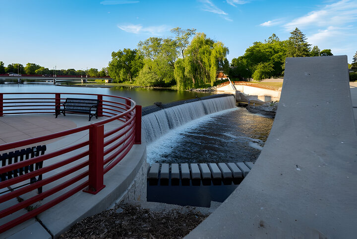 The dam in Grafton Wisconsin during a warm summer evening features a waterfall