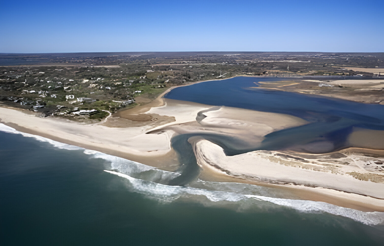 Aerial view of Southampton, New York with shoal and inlet.