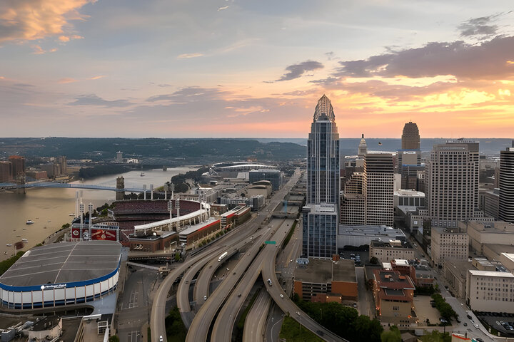 Cincinnati, Ohio evening cityscape with big highway junction and high-rise buildings of downtown district.