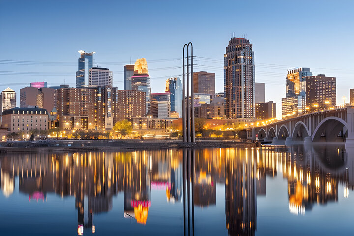 Minneapolis, Minnesota, USA downtown city skyline on the Mississippi river at dusk.