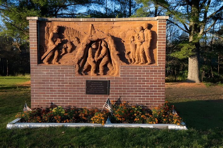 Historical memorial marker for the cities of Montreal and Gile honoring the mining and loggers who founded the community