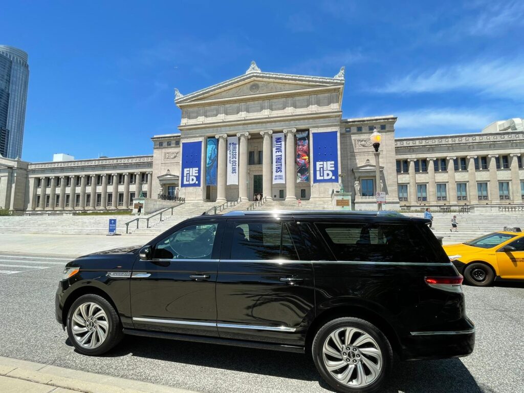 Luxury black suv standing in front of a building